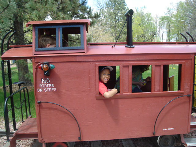 Joachim and Dylan in caboose of City Park train, Fort Collins, Colorado, 2010