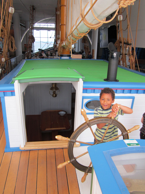Joachim steering a ship in the Discovery museum, Milwaukee, Wisconsin, 2011