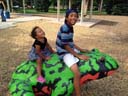 Irene and Joachim on frog sculpture at City Park, Fort Collins, Colorado, 2016